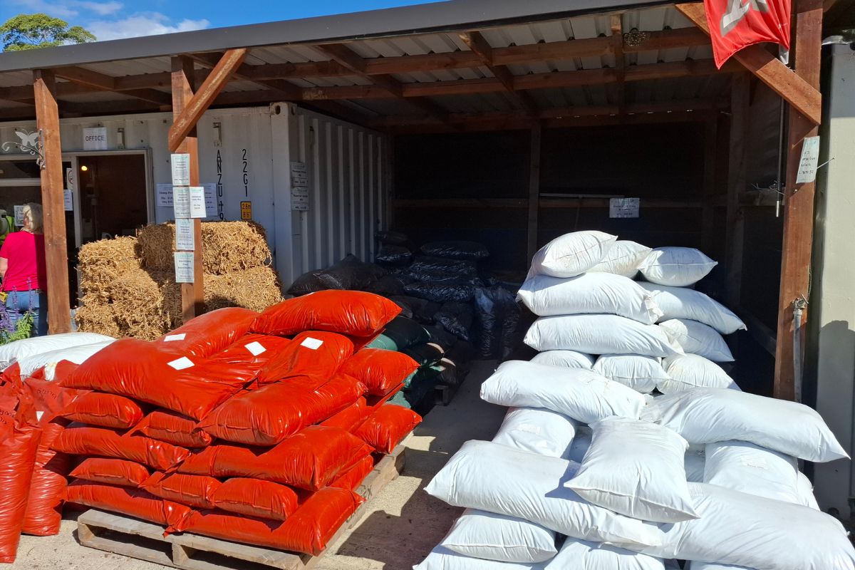bagged compost and bagged potting mix ready for pickup as well as pea straw bales near me
